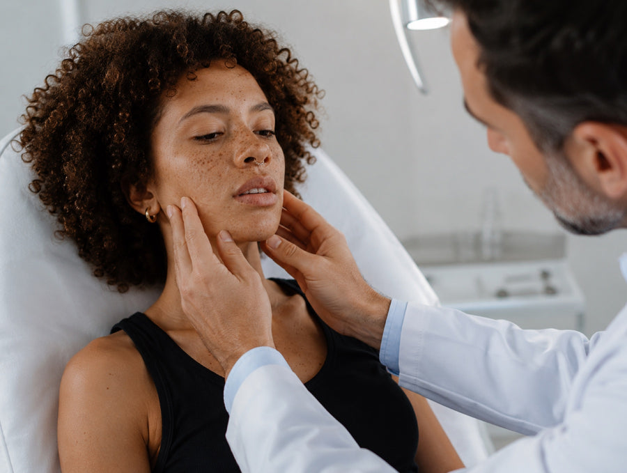 Clinician examining a patient's temporomandibular joint